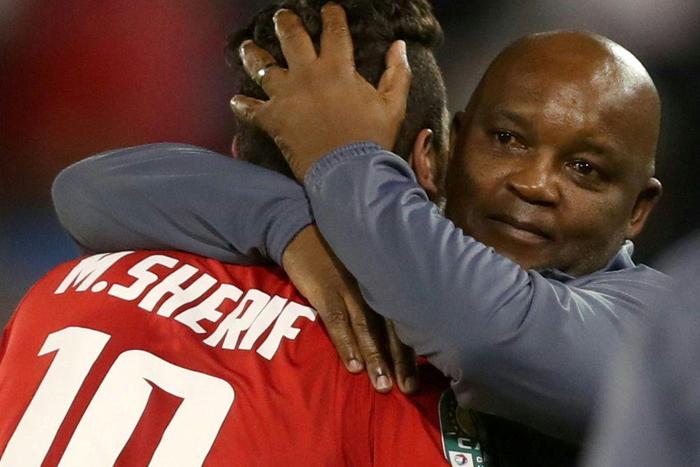 Al Ahly coach Pitso Mosimane (R) celebrates with star forward Mohamed Sherif (L) after the Egyptian club won the CAF Super Cup last May.