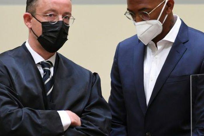 Former Bayern Munich defender Jerome Boateng (R) and his lawyer Kai Walden in court in Munich