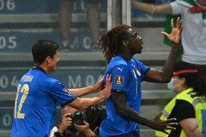 Moise Kean (R) celebrates his opening goal for Italy against Lithuania