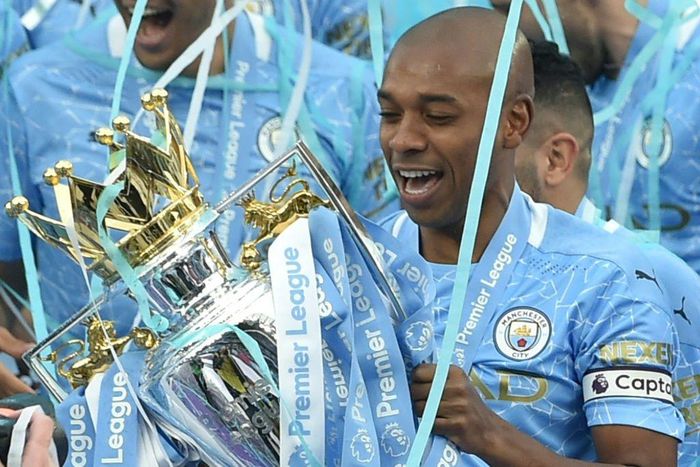 Manchester City midfielder Fernandinho lifts the Premier League trophy