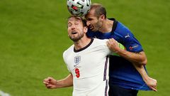 Italy defender Giorgio Chiellini (R) vies for the header with England's Harry Kane
