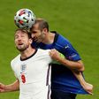 Italy defender Giorgio Chiellini (R) vies for the header with England's Harry Kane