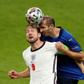 Italy defender Giorgio Chiellini (R) vies for the header with England's Harry Kane