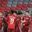 Thomas Mueller (2ndL) celebrates his assist for Bayern Munich defender Dayot Upamecano (4thL) on Friday