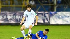 El Salvador's Ronald Rodríguez and USA's Brenden Aaronson contest a challenge in Thursday's World Cup qualifier