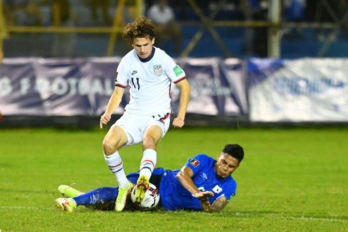 El Salvador's Ronald Rodríguez and USA's Brenden Aaronson contest a challenge in Thursday's World Cup qualifier
