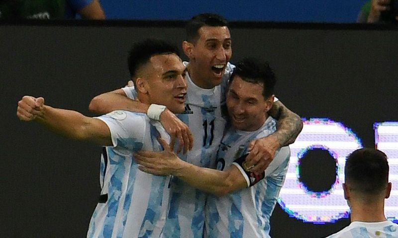 Lautaro Martinez (left) celebrates with his Argentina teammates Angel Di Maria (center) and Lionel Messi (right) after opening the scoring against Venezuela