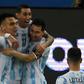 Lautaro Martinez (left) celebrates with his Argentina teammates Angel Di Maria (center) and Lionel Messi (right) after opening the scoring against Venezuela