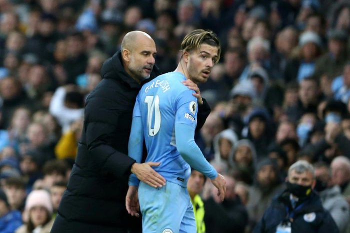 Manchester City manager Pep Guardiola talks to Jack Grealish