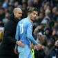 Manchester City manager Pep Guardiola talks to Jack Grealish