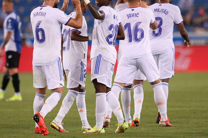 RReal Madrid's Brazilian forward Vinicius celebrates with teammates after netting in his side's opening day 4-1 thrashing of Alaves