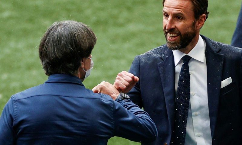 England coach Gareth Southgate (R) greets Germany boss Joachim Loew