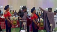 Bride refuses to smile or dance as groom sprays cash on her but people say it’s a tradition (video)