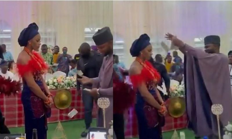 Bride refuses to smile or dance as groom sprays cash on her but people say it’s a tradition (video)