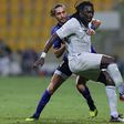 Bafetimbi Gomis holds of Esteghlal defender Siavash Yazdani