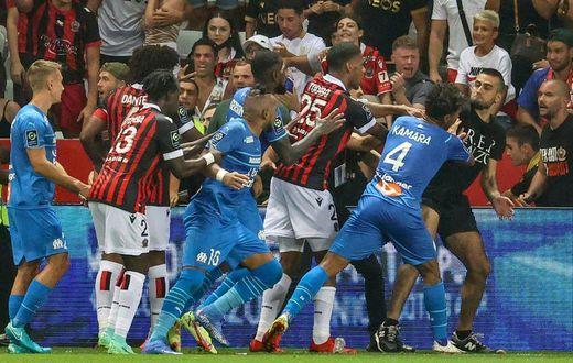 Flashpoint: Marseille's French midfielder Dimitri Payet (centre) reacts as players stop a fan  invading the pitch