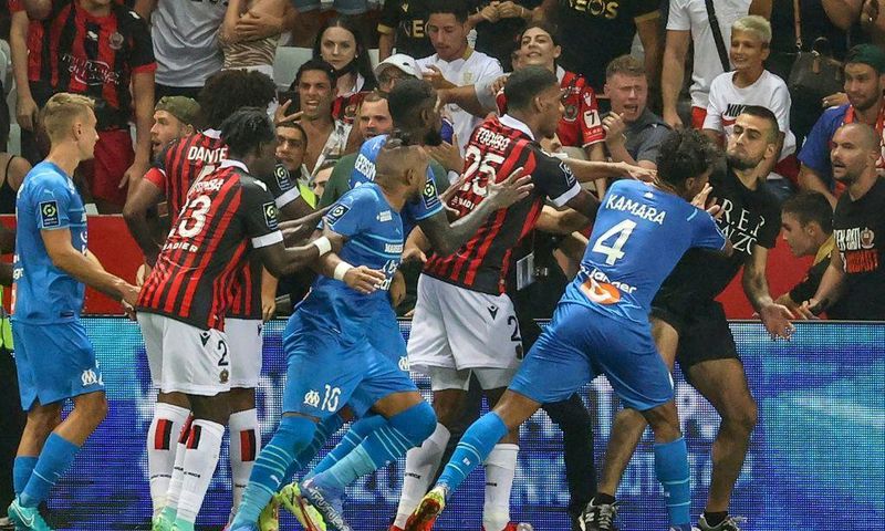 Flashpoint: Marseille's French midfielder Dimitri Payet (centre) reacts as players stop a fan  invading the pitch