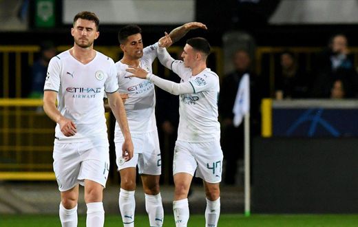 Joao Cancelo (C) celebrates scoring Manchester City's opener away to Club Brugge