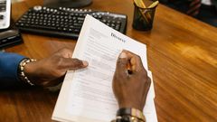 Close-up shot of a person holding divorce papers [Image: RDNE Stock Project]