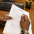 Close-up shot of a person holding divorce papers [Image: RDNE Stock Project]