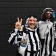 Newcastle fans pose in Arab-style clothing at St James' Park