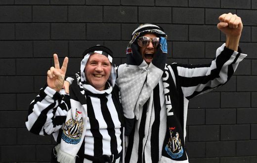 Newcastle fans pose in Arab-style clothing at St James' Park