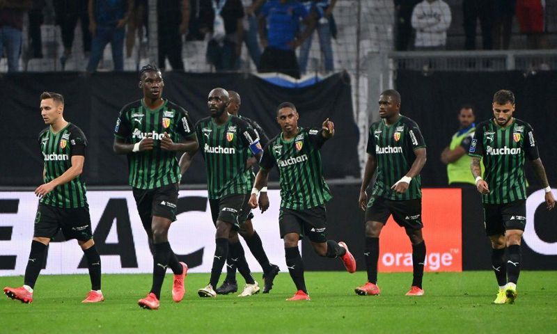 Match winner: Wesley Said (centre) celebrates scoring Lens' third goal
