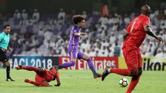 On the run: Al-Ain's Omar Abdulrahman (centre)