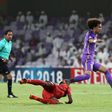 On the run: Al-Ain's Omar Abdulrahman (centre)