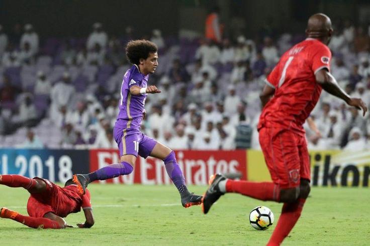 On the run: Al-Ain's Omar Abdulrahman (centre)