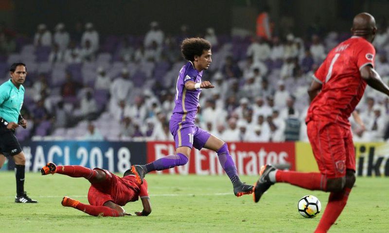On the run: Al-Ain's Omar Abdulrahman (centre)