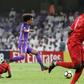 On the run: Al-Ain's Omar Abdulrahman (centre)