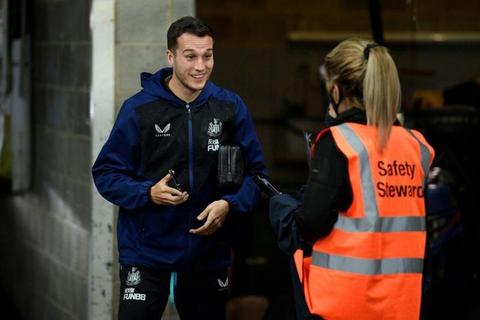 Newcastle's Javier Manquillo (L) has his Covid status checked