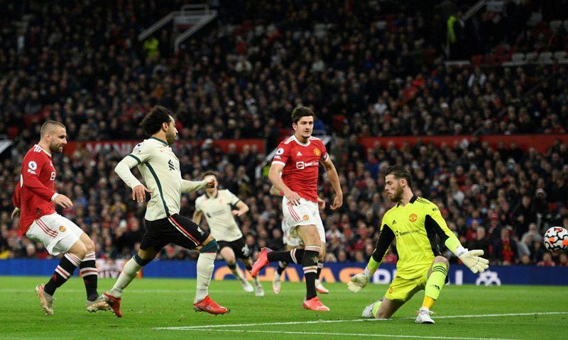 Liverpool forward Mohamed Saleh (2L) completes his hat-trick against Manchester United at Old Trafford on Sunday.