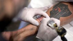 A fan of Brazilian team Atletico Mineiro gets a free tattoo offered by the company constructing the new stadium after the squad won the Brazilian Championship