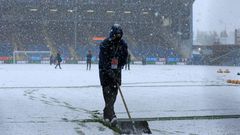 Groundstaff clear snow at Burnley's Turf Moor ground