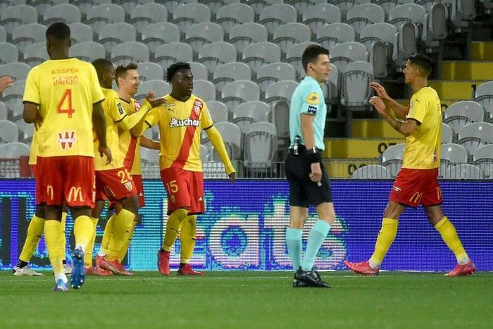 On target: Lens forward Arnaud Kalimuendo (centre) celebrates his second goal