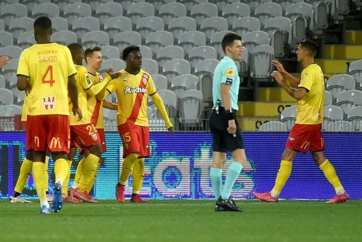On target: Lens forward Arnaud Kalimuendo (centre) celebrates his second goal
