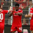 Union Berlin's Nigerian striker Taiwo Awoniyi (C) celebrates his goal on Sunday