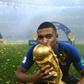 France's forward Kylian Mbappe kisses the World Cup trophy after the Russia 2018 World Cup final.