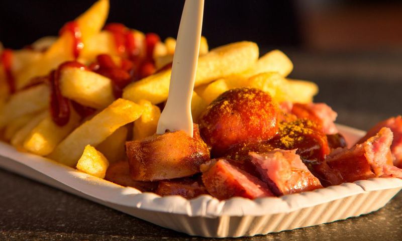 Currywurst is a popular German fast-food dish, consisting of Bratwurst covered in tomato and curry sauce and served with french fries.