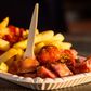 Currywurst is a popular German fast-food dish, consisting of Bratwurst covered in tomato and curry sauce and served with french fries.