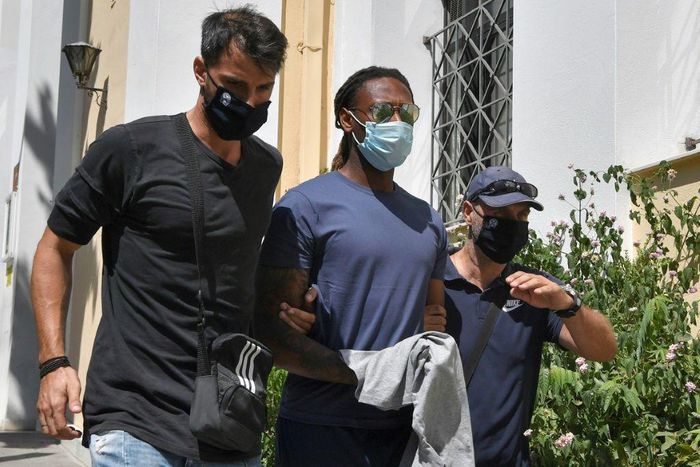 Olympiakos footballer Ruben Semedo is led away from a court hearing by police