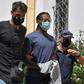 Olympiakos footballer Ruben Semedo is led away from a court hearing by police
