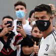 Juventus forward Cristiano Ronaldo is greeted by fans as he arrives for his medical examination at the Juventus medical center in Turin.