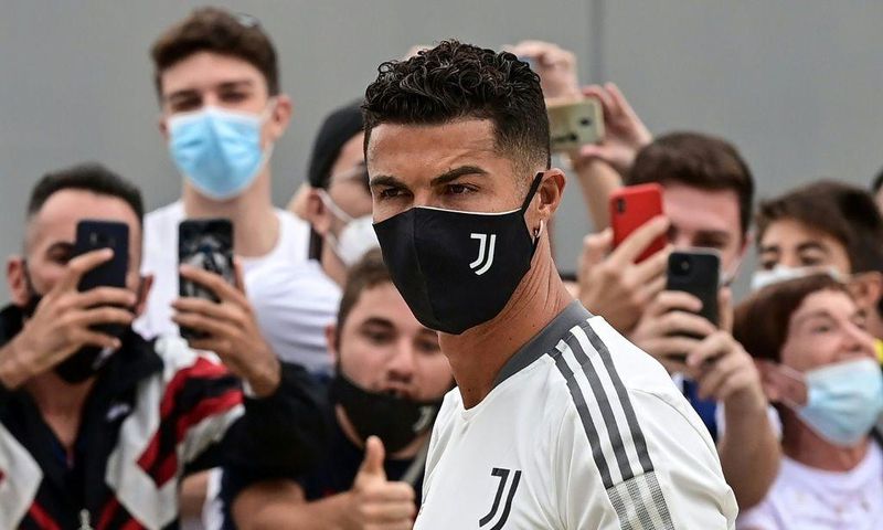 Juventus forward Cristiano Ronaldo is greeted by fans as he arrives for his medical examination at the Juventus medical center in Turin.