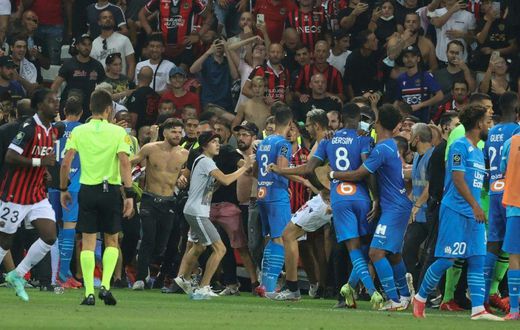 The match between Nice and Marseille was halted in the 75th minute as bottles were thrown and fans invaded the pitch
