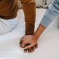 Couple holding hands on bed [Image: Alex Green]