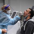 A man takes a COVID-19 test at Sydney International Airport on November 28, 2021.
