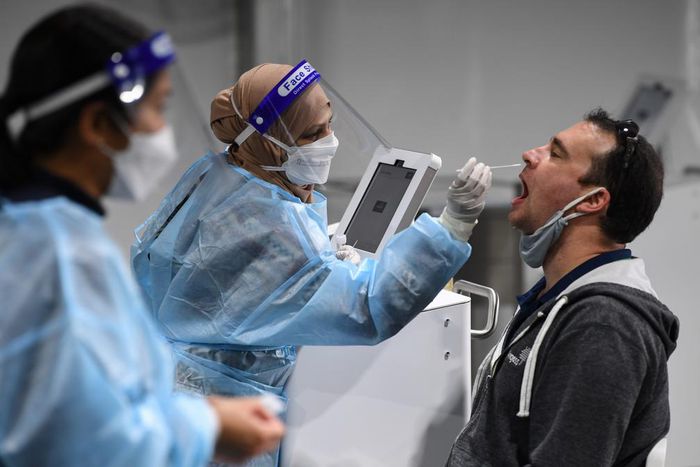 A man takes a COVID-19 test at Sydney International Airport on November 28, 2021.